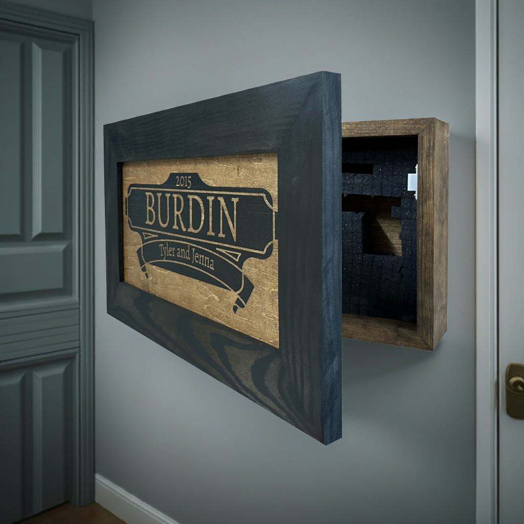 Bellewood Designs hidden gun storage wall decor in black and gold, open in entryway showing foam-lined interior