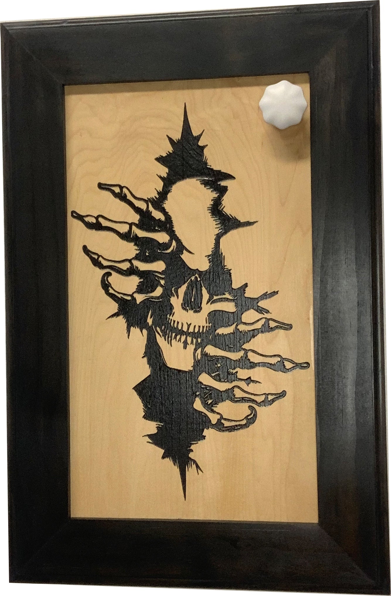 Bellewood Designs gothic skull claw hidden gun cabinet front view with magnetic key on dark wood frame