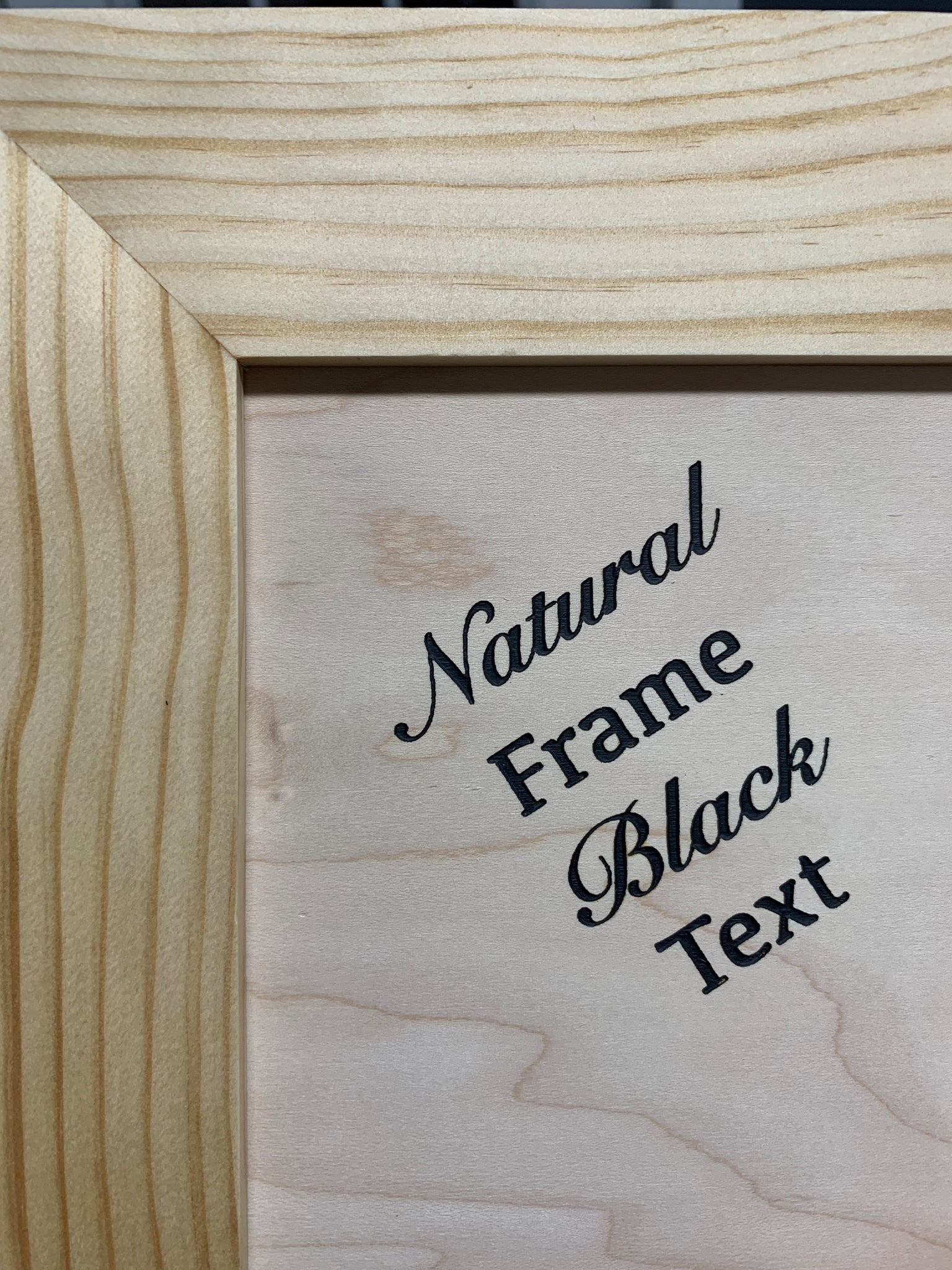 Bellewood Designs hidden gun cabinet natural wood frame with black engraved text on wood panel closeup