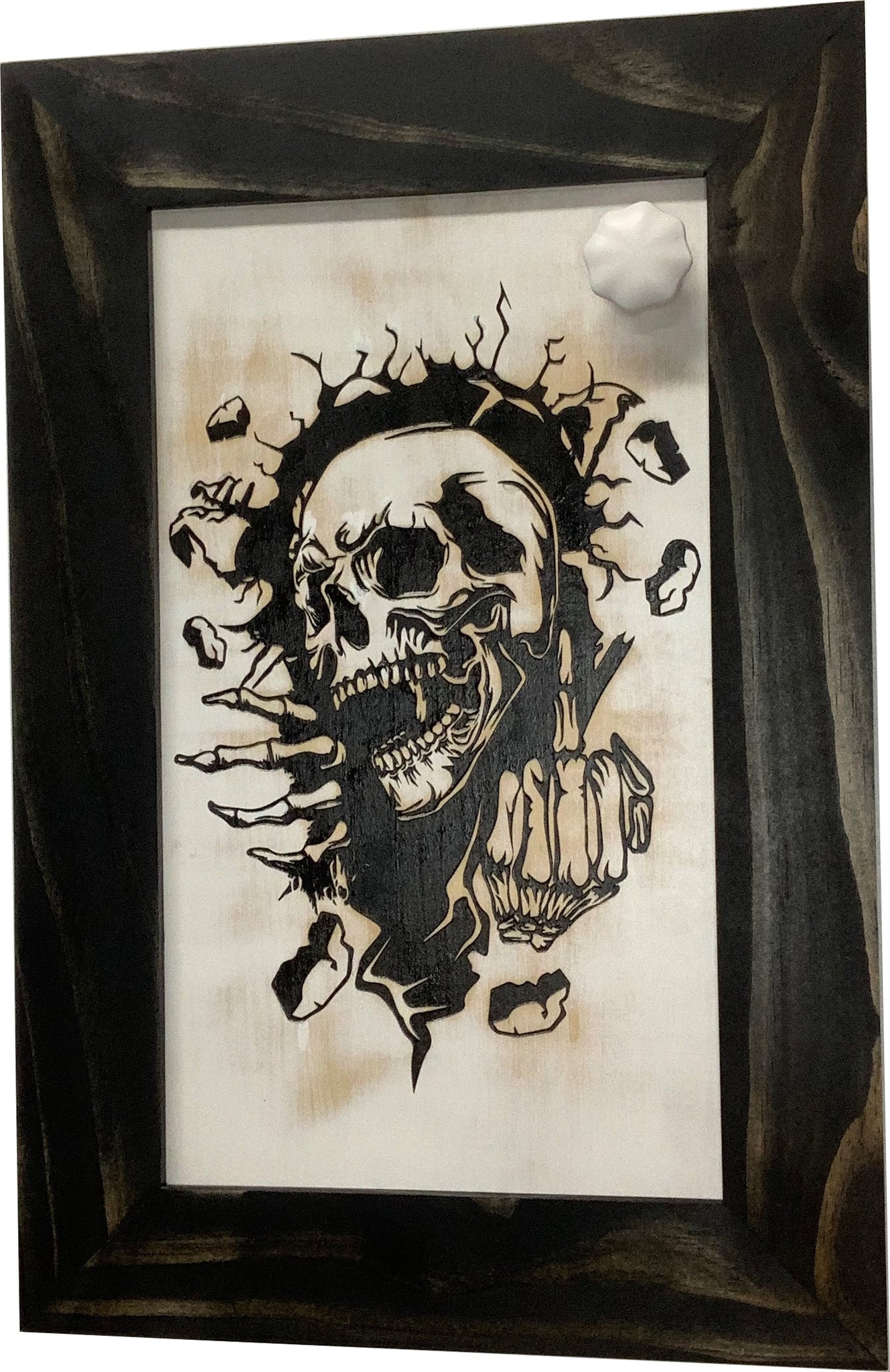 Bellewood Designs skull hidden gun cabinet wall art with magnetic key attached to dark wood frame
